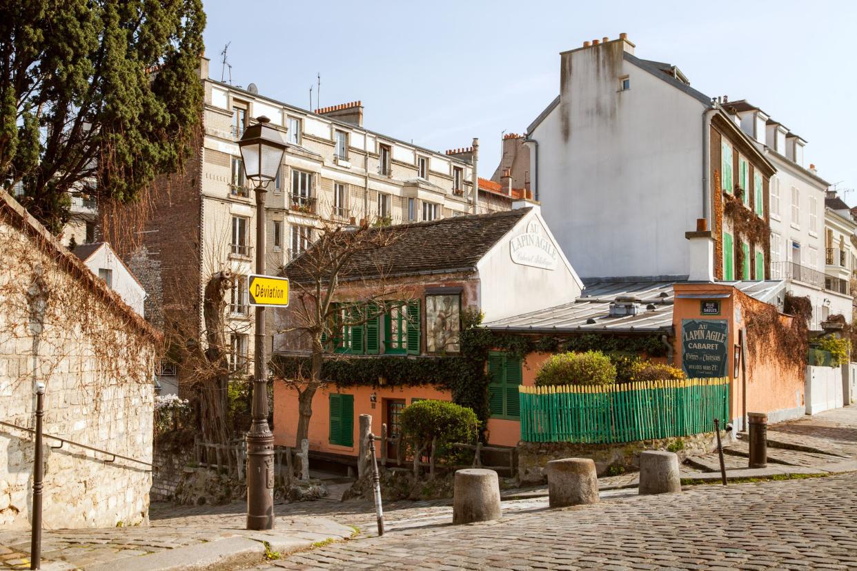 Paris, France - MAR 28, 2019: Au lapin agile cabaret on Saint-Vincent street in sunny spring day