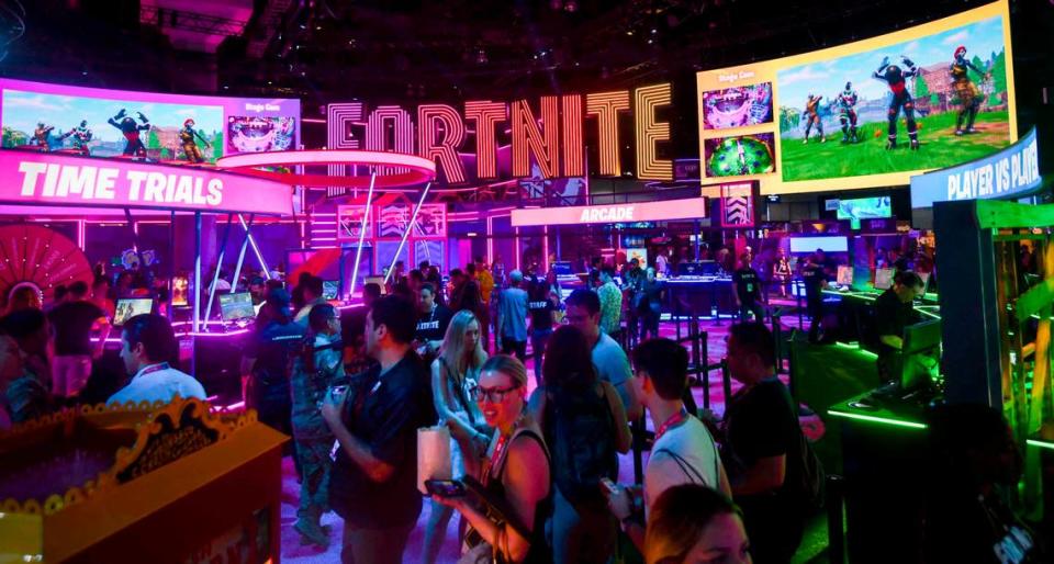 E3 participants walk through the Fortnite section of the wing at the 2019 Electronic Entertainment Expo (E3) at the Los Angeles Convention Center.