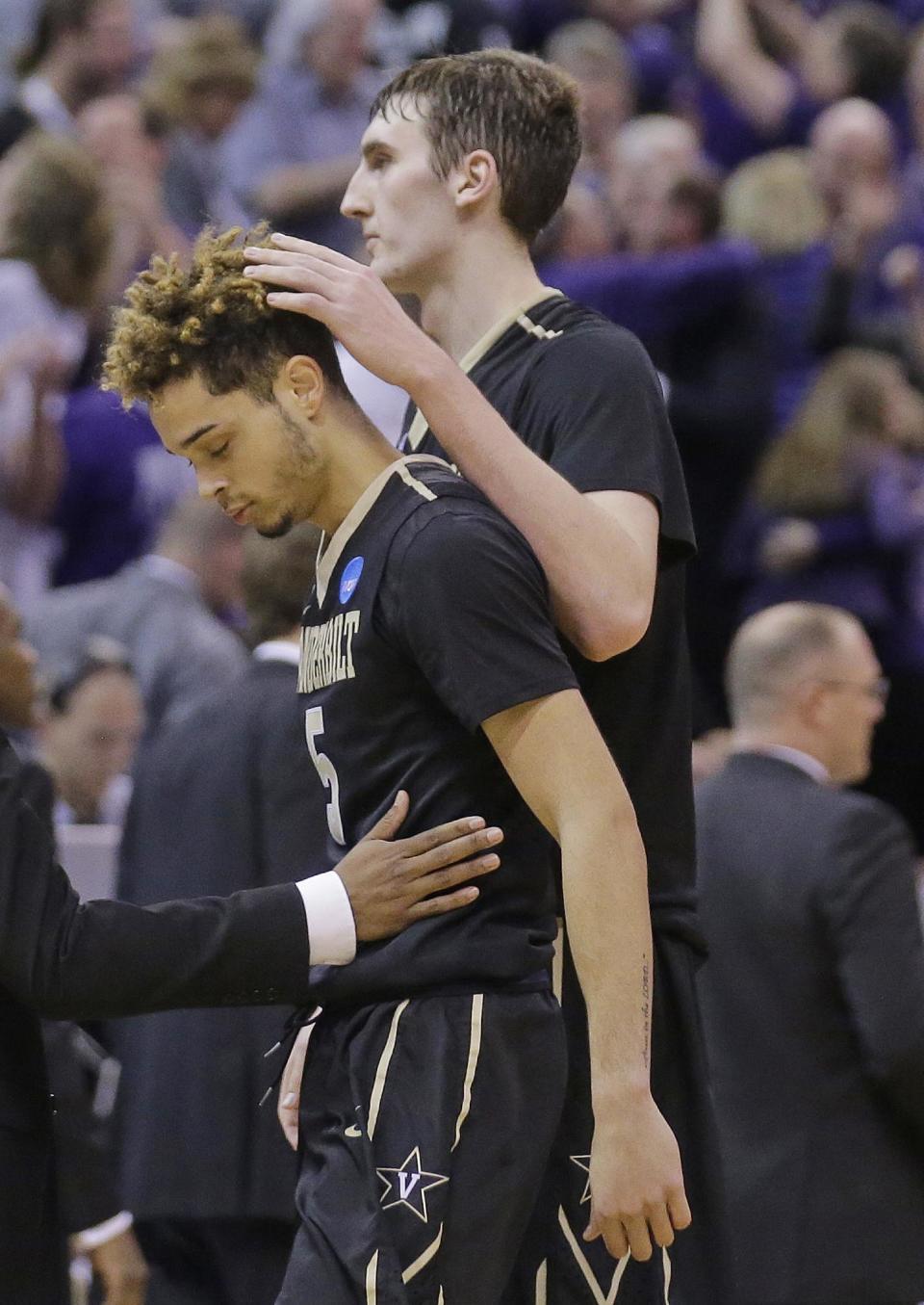 Vanderbilt's Luke Kornet, right, consoles guard Matthew Fisher-Davis (5) following the team's 68-66 loss to Northwestern in a first-round game of the NCAA men's college basketball tournament Thursday, March 16, 2017, in Salt Lake City. (AP Photo/Rick Bowmer)