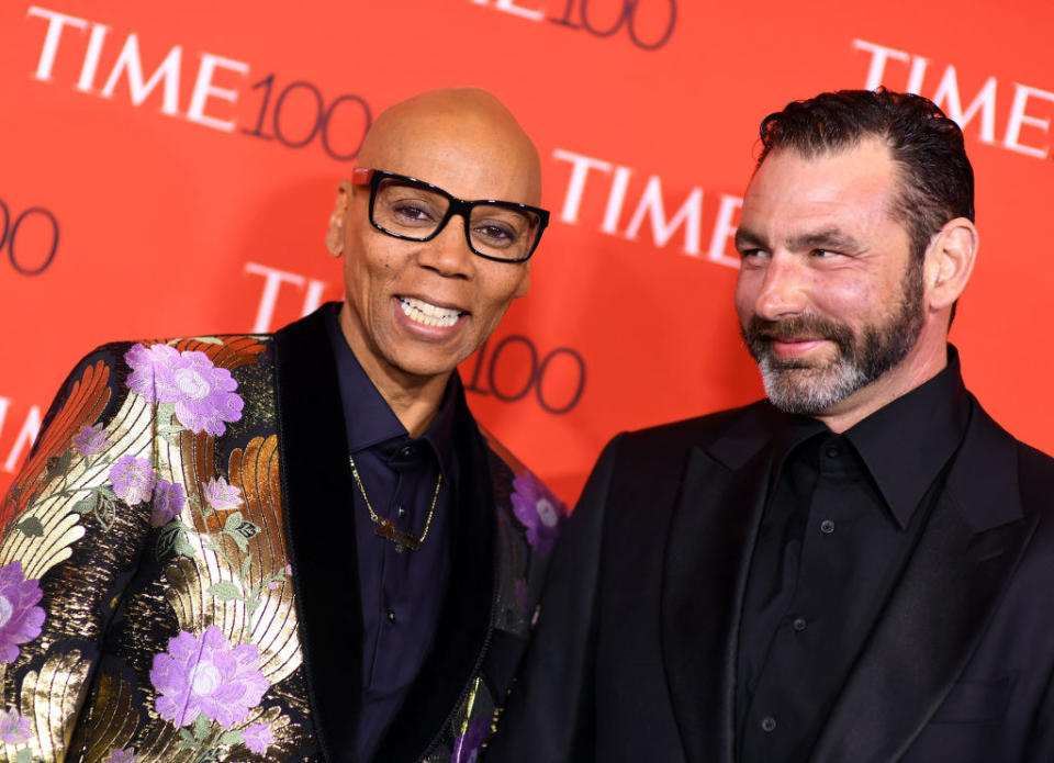 Georges smiling at RuPaul on a red carpet