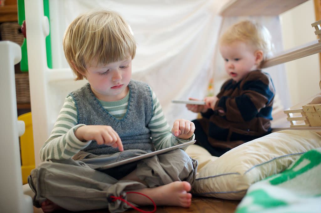 Boy (4-5) and Girl (1) play with iPad and iPhone