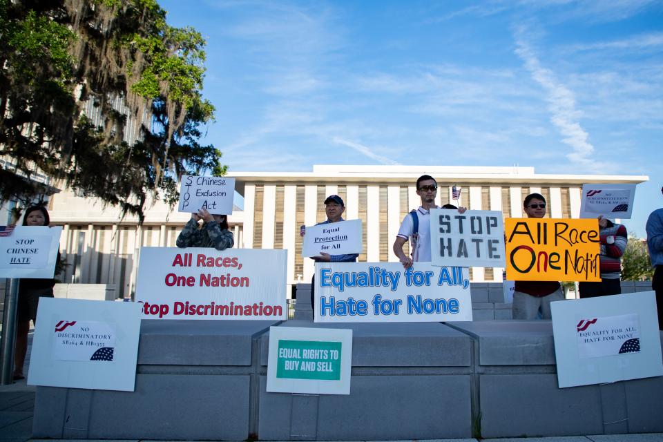 Dozens gather in front of the Capitol to voice their opposition to SB264 and HB1355 on Wednesday, April 19, 2023. The bills state that Chinese-Americans would not be allowed to purchase homes in Florida.