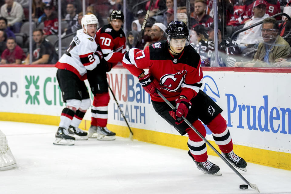 New Jersey Devils center Yegor Sharangovich (17) skates with the puck during the third period of the team's NHL hockey game against the Ottawa Senators, Thursday, Nov. 10, 2022, in Newark, N.J. The Devils won 4-3 in overtime. (AP Photo/Julia Nikhinson)