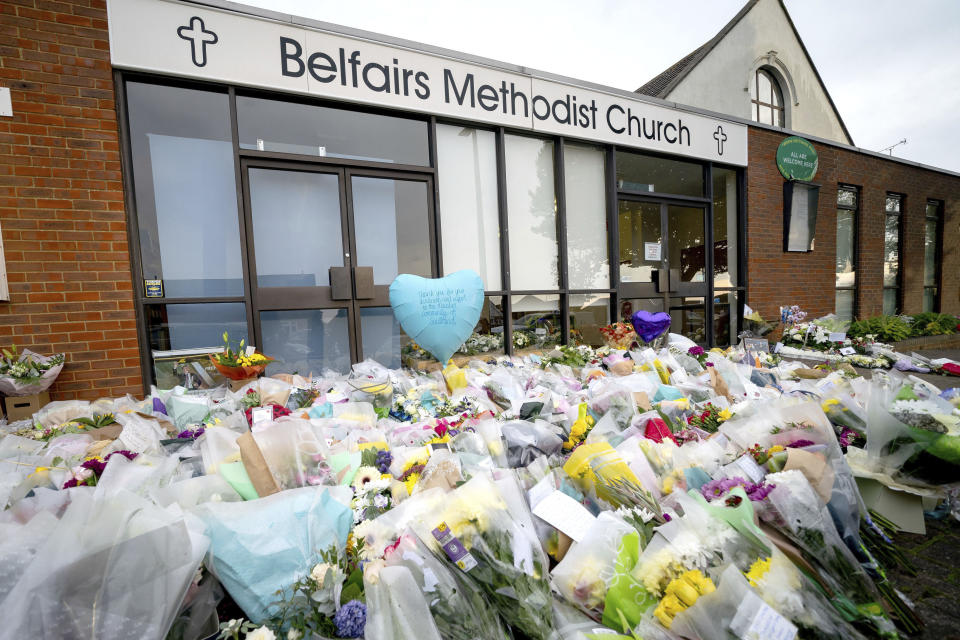 Flowers and tributes at the scene outside Belfairs Methodist Church where Conservative MP David Amess died after he was stabbed several times at a constituency surgery on Friday, in Leigh-on-Sea, Essex, England, Monday, Oct. 18, 2021. British Prime Minister Boris Johnson will lead tributes in the House of Commons to David Amess, a Conservative lawmaker stabbed to death as he met constituents in a church hall. The death of Amess has shocked British politicians. It came five years after Labour Party lawmaker Jo Cox was murdered by a far-right extremist. (Aaron Chown/PA via AP)