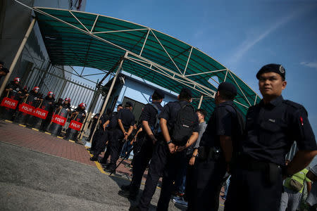 Riot police officers stand guard outside the entrance of Subang airport near Kuala Lumpur, Malaysia, May 12, 2018. REUTERS/Athit Perawongmetha