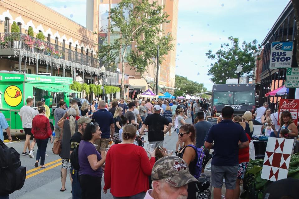 A crowd of people make their way around Palafox Place in downtown Pensacola during Gallery Night on July 16, 2021.