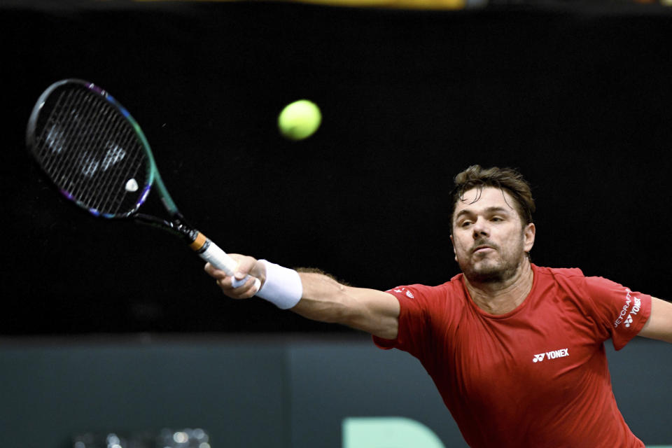 Switzerland's Stan Wawrinka returns to Germany's Alexander Zverev during the Davis Cup, qualifying round tennis match between Germany and Switzerland in Trier, Germany, Friday Feb. 3, 2023. (Harald Tittel/dpa via AP)