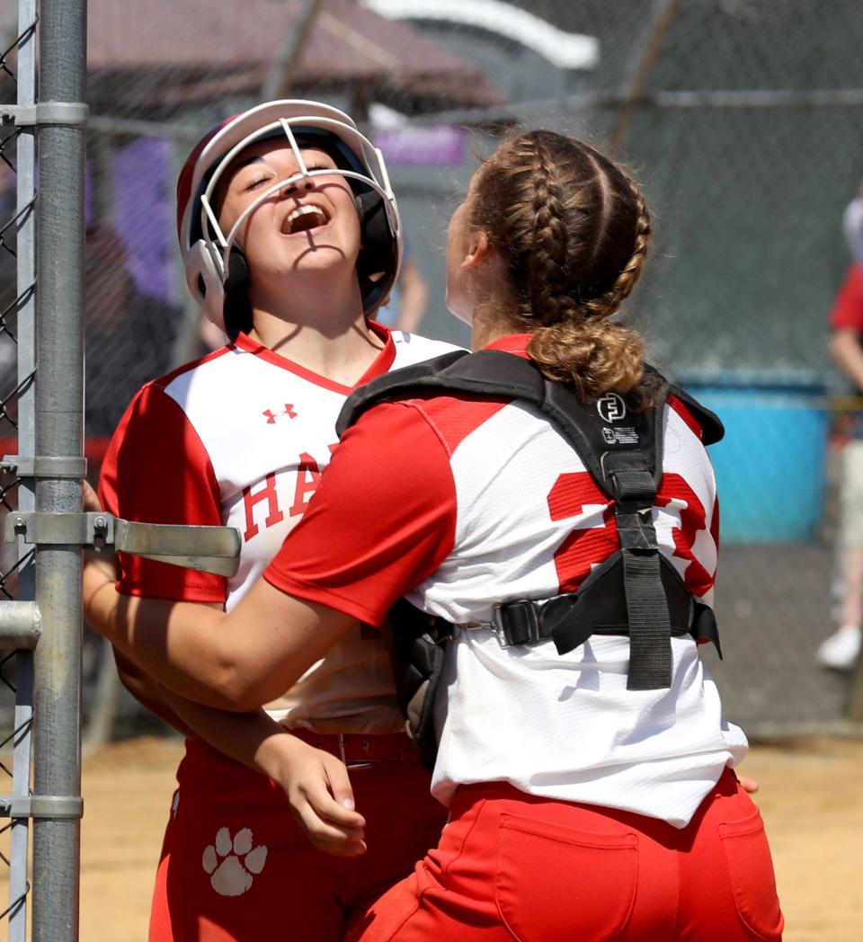 Allison Murphy, left, celebrates with Olivia Leon after scoring the first run of the game during the Section 1 Class AA softball championship against White Plains at North Rockland High School May 27, 2023. North Rockland defeated White Plains 3-2.