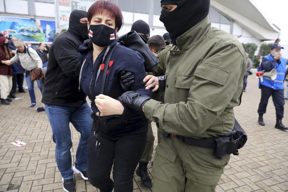 Police officers detain a woman during a rally in support of Maria Kolesnikova, a member of the Coordination Council created by the opposition to facilitate talks with Lukashenko on a transition of power, was detained Monday in the capital of Minsk with two other council members, in Minsk, Belarus, Tuesday, Sept. 8, 2020. A leading opposition activist in Belarus is being held on the border with Ukraine after she resisted attempts by authorities to deport her from the country as part of a clampdown on protests against authoritarian President Alexander Lukashenko. (AP Photo)