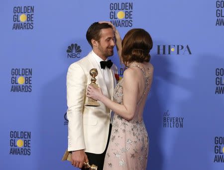 Ryan Gosling and Emma Stone pose with their awards for Best Performance by an Actor in a Motion Picture - Musical or Comedy and Best Performance by an Actress in a Motion Picture - Musical or Comedy for their roles in "La La Land" during the 74th Annual Golden Globe Awards in Beverly Hills, California, U.S., January 8, 2017. REUTERS/Mario Anzuoni