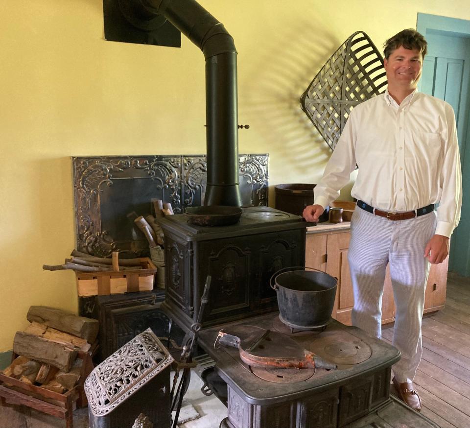 Hagen History Center Executive Director Cal Pifer is shown with a functional stove at the Yellow House on the center's Girard campus. The house has been renovated and will host a variety of public events beginning this fall.