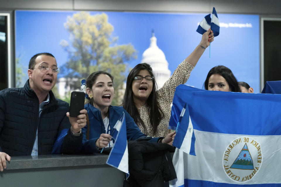 Supporters of Nicaraguan political prisoners chant at Washington Dulles International Airport, in Chantilly, Va., on Thursday, Feb. 9, 2023. Some 222 inmates considered by many to be political prisoners of the government of Nicaraguan President Daniel Ortega arrived at Washington after an apparently negotiated release. (AP Photo/Jose Luis Magana)