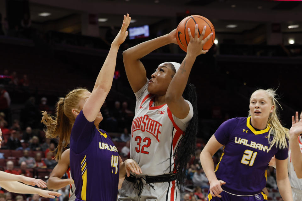 Ohio State's Cotie McMahon, center, shoots over Albany's Grace Heeps during the first half of an NCAA college basketball game on Friday, Dec. 16, 2022, in Columbus, Ohio. (AP Photo/Jay LaPrete)