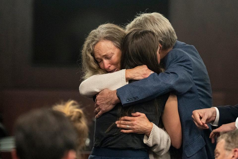 The parents of Anna "Mo" Wilson, Karen and Eric Wilson, embrace Caitlin Cash, a friend of Wilson's, after the sentencing portion of Kaitlin Armstrong's murder trial on Friday.