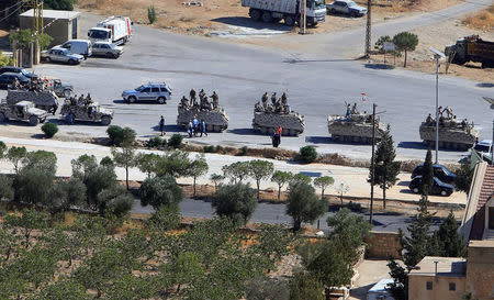 Lebanese army are seen in military tanks in the town of Ras Baalbek, Lebanon August 19, 2017. REUTERS/ Ali Hashisho