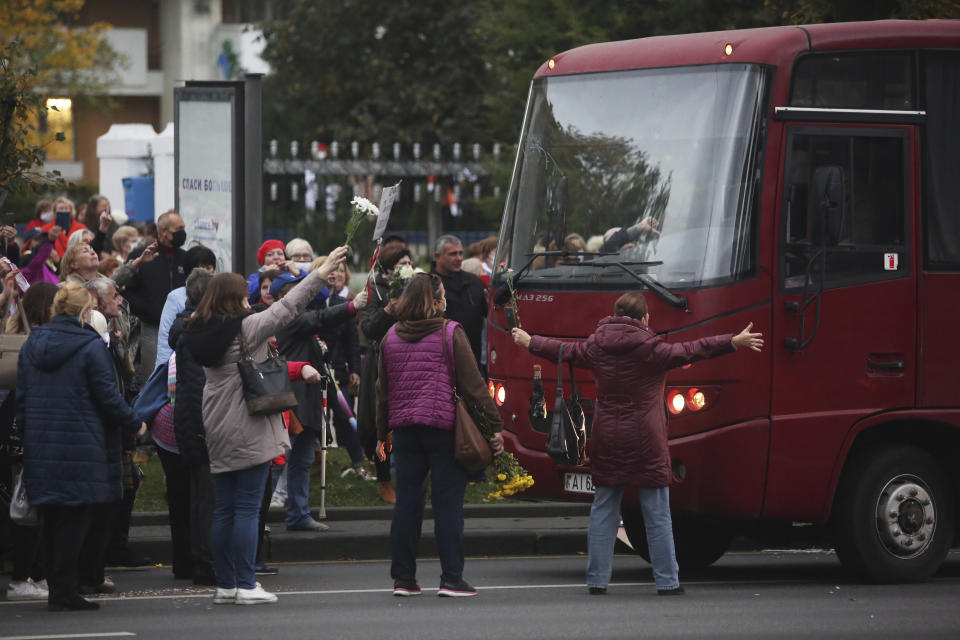 People, most of them elderly women, block a way for a police van during an opposition rally to protest the official presidential election results in Minsk, Belarus, Monday, Oct. 12, 2020. Riot police clashed with protesting pensioners in central Minsk on Monday. The pensioners marched in a column through central Minsk, carrying flowers and posters with slogans such as "The grandmas are with you (protesters)." (AP Photo)