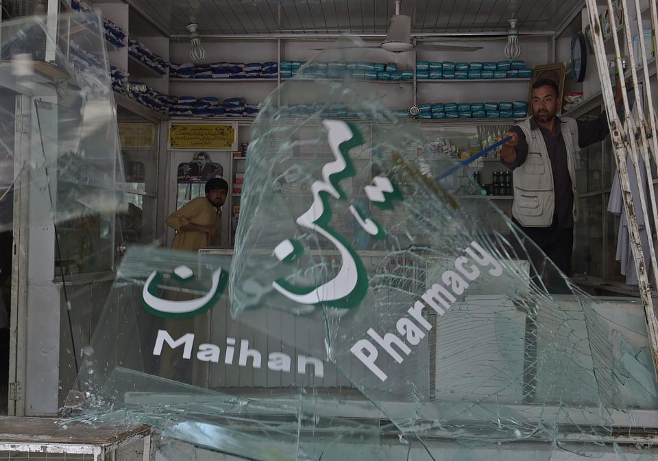 <p>Afghan shopkeepers clean up broken glass at the site of a suicide attack outside a bank near the U.S. embassy in Kabul on Aug. 29, 2017. A suicide bomber blew himself up on a busy shopping street near the US embassy in central Kabul on August 29, killing four people and injuring several others, officials said. It was the latest in a series of deadly attacks to hit the Afghan capital, and comes three months after a massive truck bomb ripped through the same area, killing about 150 people. (Photo: Shah Marai/AFP/Getty Images) </p>