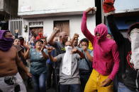 Residents protest in support of a mutiny by a national guard unit and against Venezuelan President Nicolas Maduro in the Cotiza neighborhood of Caracas, Venezuela, Monday, Jan. 21, 2019. Security forces have fired tear gas against protesters in a poor neighborhood near the presidential palace after an apparent uprising by a national guard unit. (AP Photo/Ariana Cubilos)