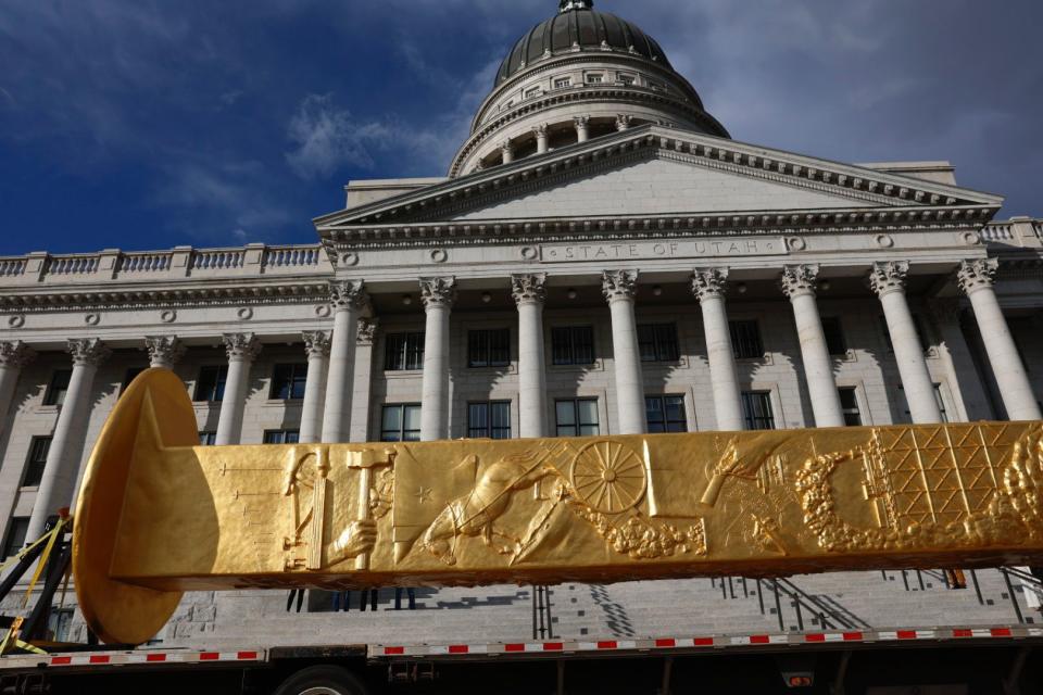 The Golden Spike Monument arrives in front of the Utah State Capitol in Salt Lake City on Monday, Oct. 23, 2023. The 43-foot-tall Golden Spike was commissioned as a public art piece by the Golden Spike Foundation to honor the tens of thousands of railroad workers who built the transcontinental railroad. | Megan Nielsen, Deseret News