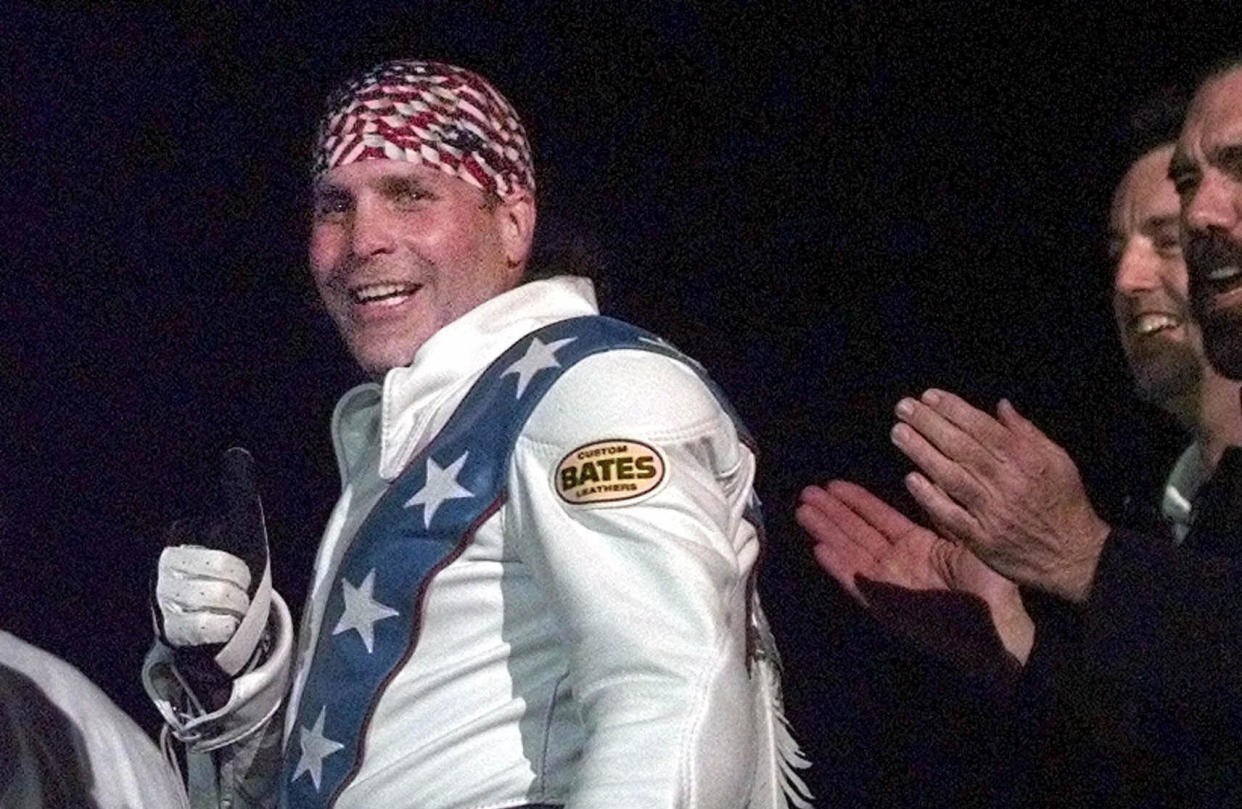 Robbie Knievel gives a thumbs-up after jumping a train at the Texas State Railroad Park in Palestine, Texas, on  Feb. 23, 2000.  / Credit: AP Photo/LM Otero