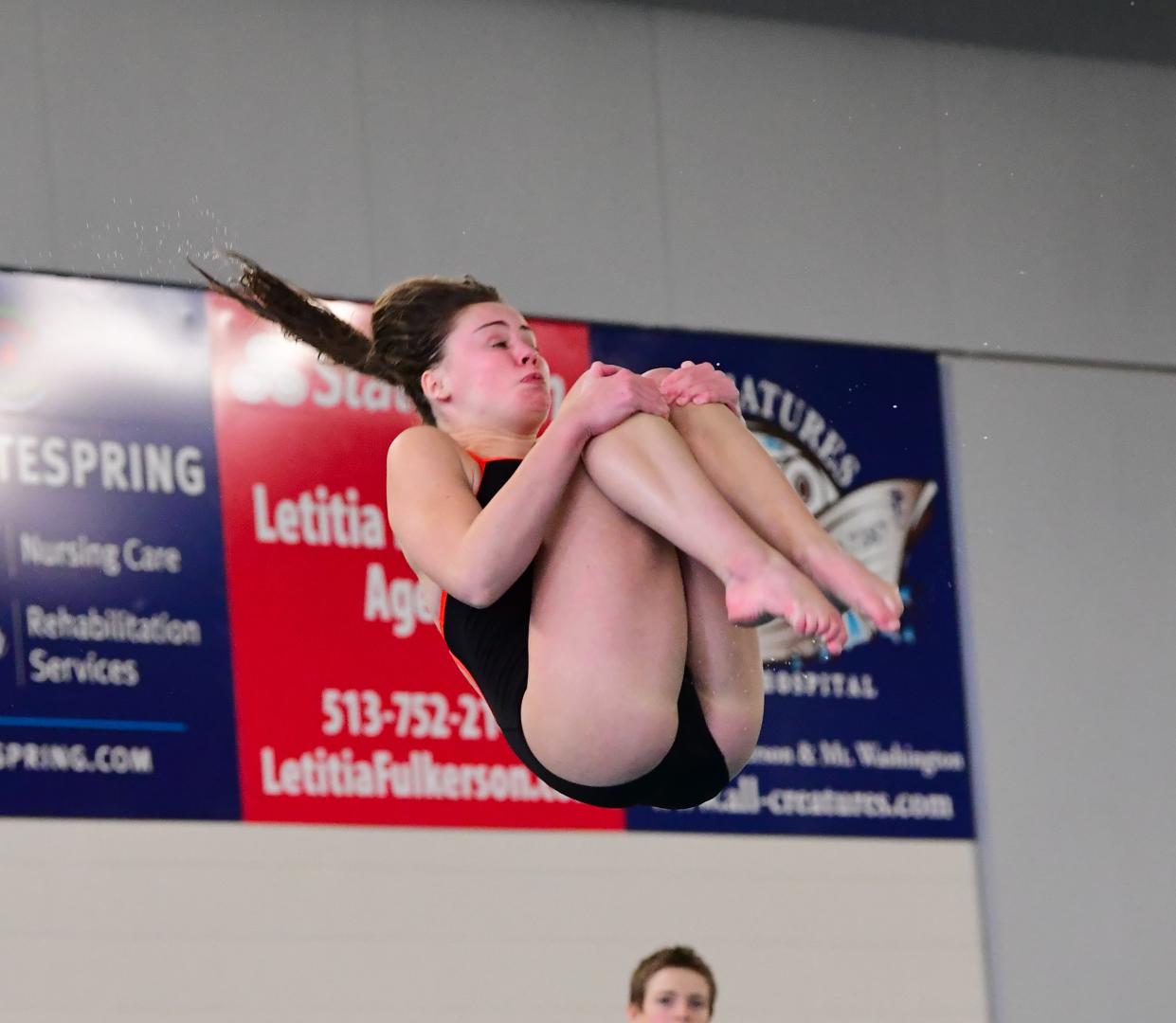 Natalie Reising of Anderson holds a tight tuck while diving in the ladies diving finals at the Southwest Ohio High School Swimming and Diving Classic at the West Clermont Natatorium, Jan. 15, 2023.