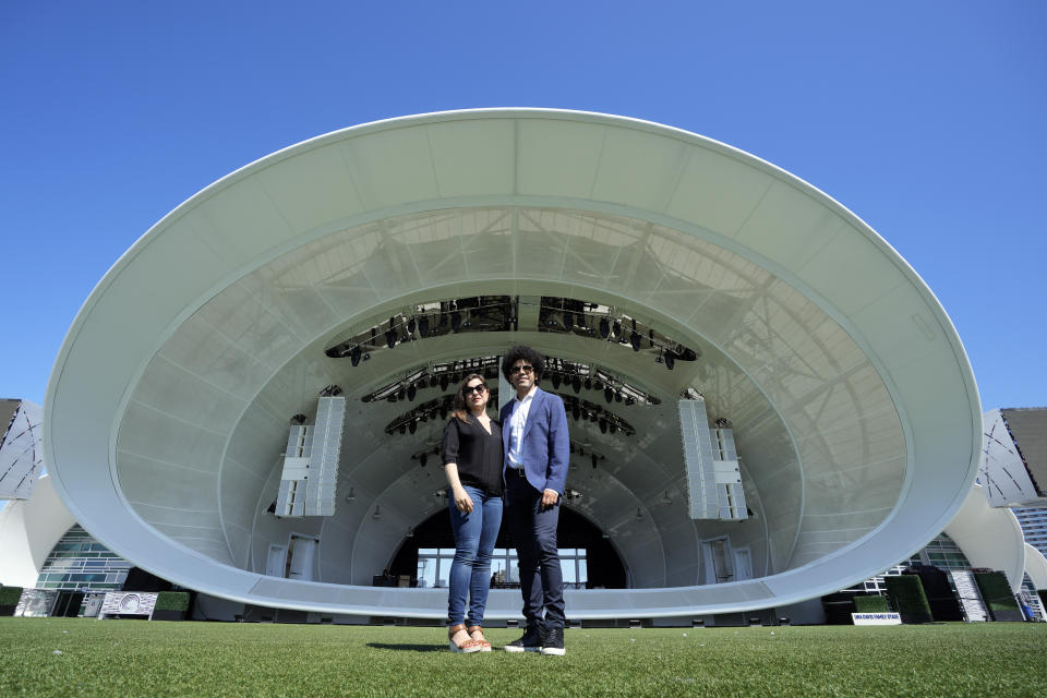 Cellist Alisa Weilerstein, left, and conductor Rafael Payare pose for a portrait at The Rady Shell at Jacobs Park, Wednesday, July 19, 2023, in San Diego. The couple are on a four-concert cross-country run that ends Friday night at Carnegie Hall. (AP Photo/Gregory Bull)