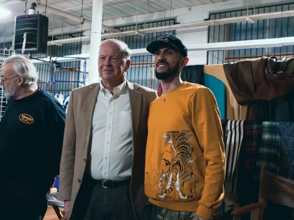 Fall River Mayor Paul Coogan and Gregory Molinar pose for a photo at a networking event for fashion designers and artists at Vanson Leathers in Fall River on Thursday, April 4, 2024. At far left is Vanson owner Michael Van Der Sleesen.