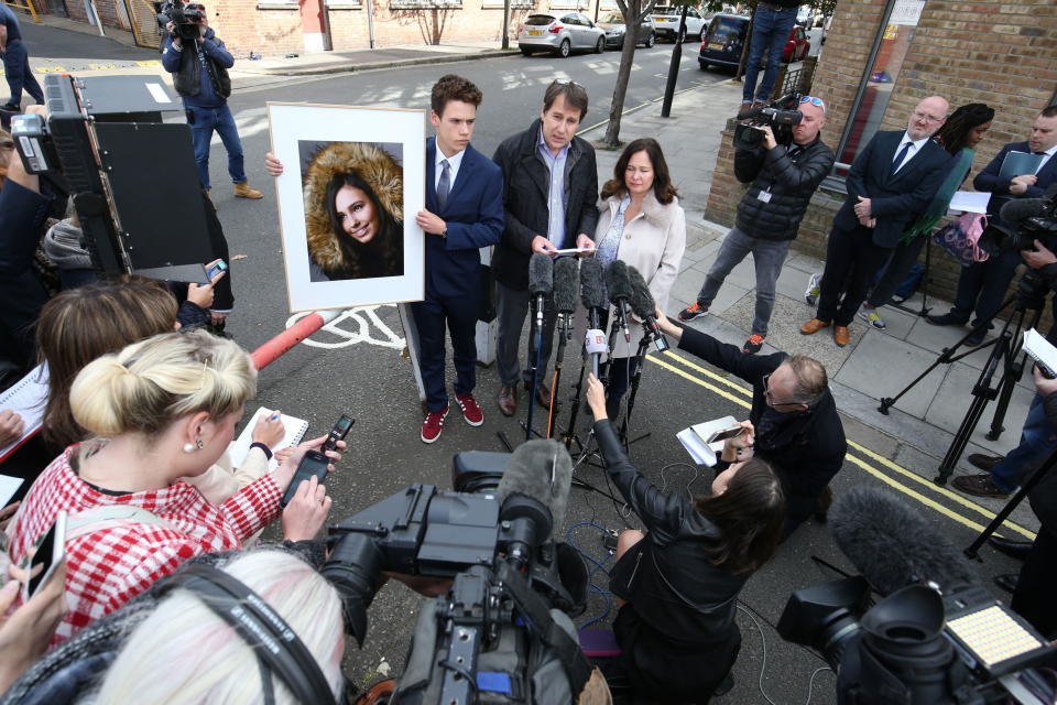 Nadim and Tanya Ednan-Laperouse, with their son Alex, speaking to the media outside West London Coroners Court, Friday Sept. 28, 2018, following the inquest into the death of Natasha Ednan-Laperouse, 15, seen on poster, who died after suffering a fatal allergic reaction on a flight from London to Nice after eating a Pret A Manger sandwich at Heathrow Airport. Natasha's father, Nadim, said Friday he hoped the death of their daughter could serve as a watershed moment to make meaningful changes to allergy labelling on food packaging. (Jonathan Brady/PA via AP)