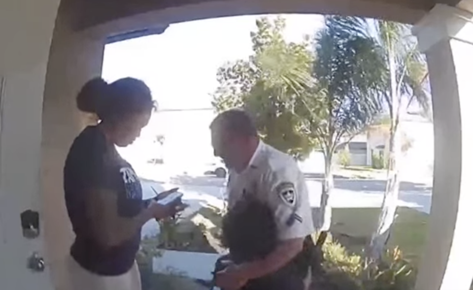 Hillsborough County Deputy Scott Pracht is seen on a doorbell camera hugging the boy who called 911.