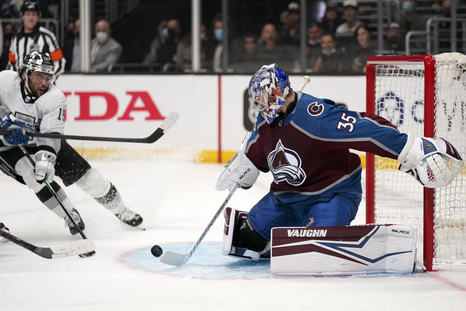 Los Angeles Kings left wing Alex Iafallo, left, attempts to score on Colorado Avalanche goaltender Darcy Kuemper during the second period of an NHL hockey game Thursday, Jan. 20, 2022, in Los Angeles. (AP Photo/Mark J. Terrill)