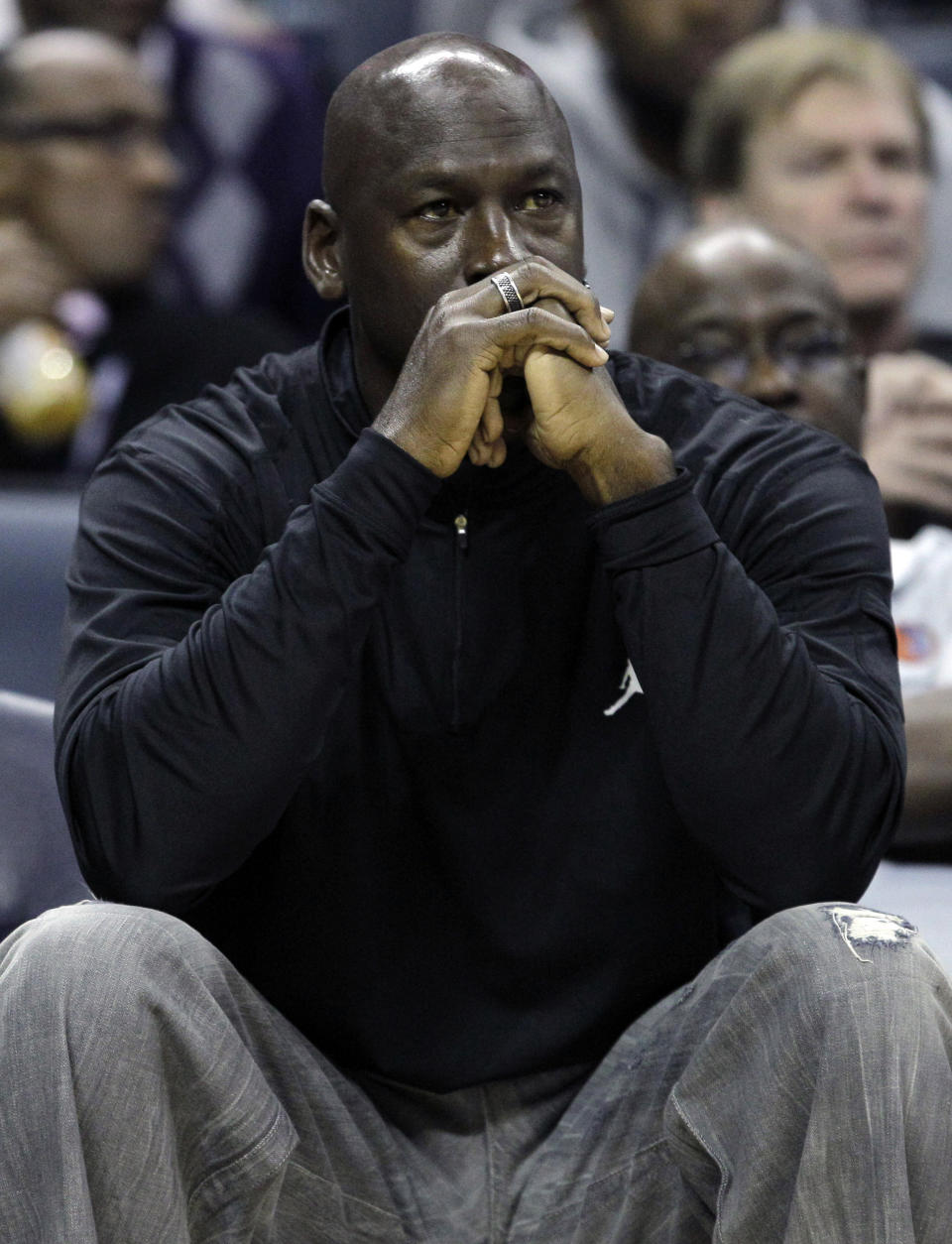 FILE - In this Jan. 16, 2012, file photo, Charlotte Bobcats owner Michael Jordan watches during the first half of an NBA basketball game between the Bobcats and the Cleveland Cavaliers in Charlotte, N.C. Jordan's No. 23 has long been synonymous with greatness. By Thursday night, that number could have a completely different meaning. If Jordan's Charlotte Bobcats lose to the New York Knicks, it will be their 23rd consecutive loss and they'll finish the season with the worst winning percentage in NBA history. (AP Photo/Chuck Burton, File)