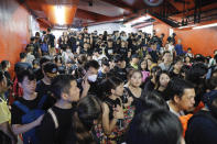 Protesters file into a subway station near Victoria Park in Hong Kong on Sunday, Aug. 18, 2019. Heavy rain fell on tens of thousands of umbrella-toting protesters Sunday as they marched from a packed park and filled a major road in Hong Kong, where mass pro-democracy demonstrations have become a regular weekend activity over the summer. (AP Photo/Kin Cheung)