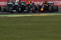 Mercedes' Lewis Hamilton, left, and Red Bull's Max Verstappen compete during the Formula One Mexico Grand Prix auto race at the Hermanos Rodriguez racetrack in Mexico City, Sunday, Nov. 7, 2021. (AP Photo/Fernando Llano)