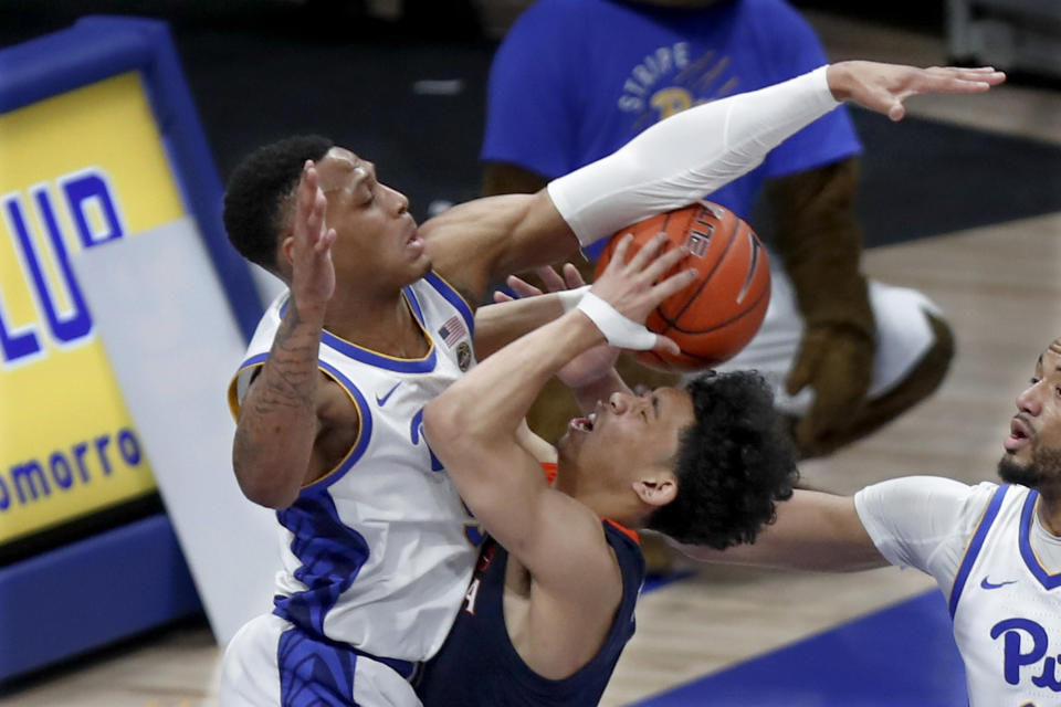 Pittsburgh's Au'Diese Toney, left, defends as Virginia's Kihei Clark shoots during the second half of an NCAA college basketball game, Saturday, Feb. 22, 2020, in Pittsburgh. (AP Photo/Keith Srakocic)