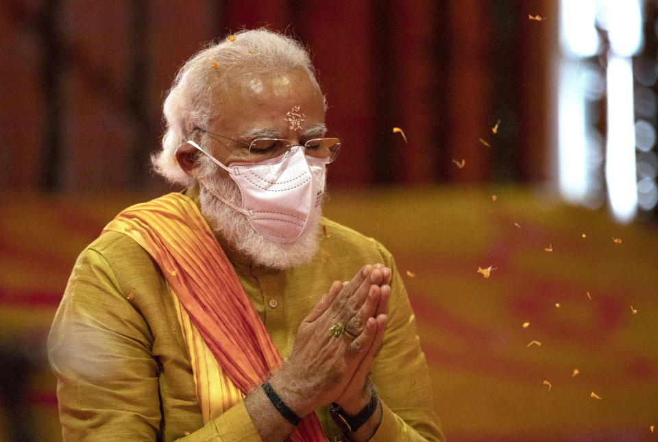 FILE- Indian Prime Minister Narendra Modi performs rituals during the groundbreaking ceremony of a temple dedicated to the Hindu god Ram, at the site of a demolished 16th century mosque, in Ayodhya, India on Aug. 5, 2020. Hindus believe the site of the mosque was the exact birthplace of their god Ram. Its demolition in 1992 sparked massive communal violence across India that left more than 2,000 people dead, mostly Muslims, and catapulted Prime Minister Narendra Modi's Bharatiya Janata Party to national prominence. (AP Photo/Rajesh Kumar Singh, File)