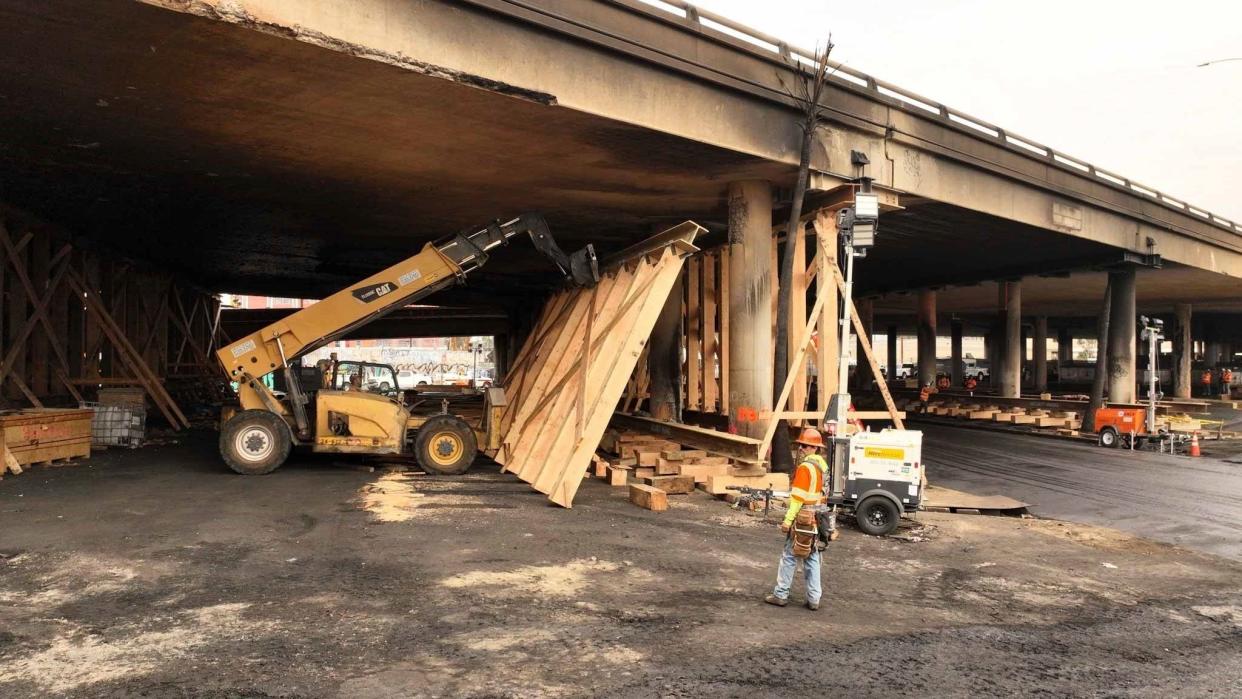 This photo provided by the California Department of Transportation shows a work crew shoring up a section under Interstate 10 that was severely damaged in a fire in an industrial zone near downtown Los Angeles on Wednesday, Nov. 15, 2023. The area under the freeway that burned last weekend, damaging a section of a key thoroughfare in the car-dependent city, was stacked with flammable materials on lots leased by the state through a little-known program that now is under scrutiny.