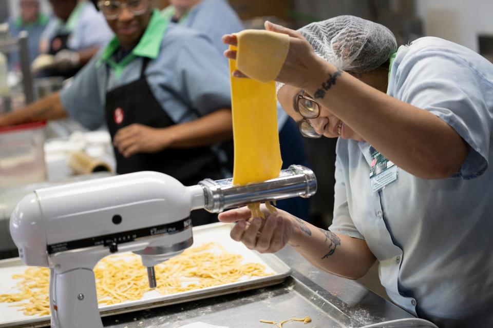 Violet Valdez rolls fresh pasta dough during a cooking class through Sinclair Community College at the Ohio Reformatory for Women. The class teaches women basic cooking skills, including how to make handmade pasta and other basics.