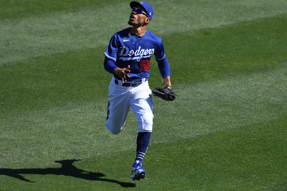 GLENDALE, ARIZONA - MARCH 08: Mookie Betts #50 of the Los Angeles Dodgers runs to make a catch against the Chicago White Sox during a spring training game at Camelback Ranch on March 08, 2021 in Glendale, Arizona. (Photo by Norm Hall/Getty Images)
