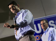 U.S. Republican presidential candidate Mitt Romney (R) stands as his vice president selection, U.S. Congressman Paul Ryan (R-WI) speak at a campaign event at the NASCAR Technical Institute in Mooresville, North Carolina August 12, 2012. REUTERS/Shannon Stapleton