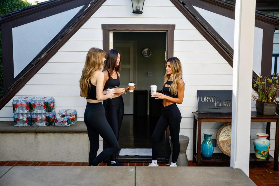 Liana Levi, owner of Forma Pilates, chats with her students Kassia Taylor and Colleen McCabe at her home studio.