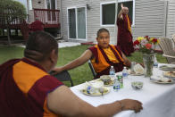 Tibetan Buddhism meditation and mentor Khenpo Kunga, left, talks with 14-year-old Buddhist lama Jalue Dorje after a dinner on Monday, July 19, 2021 in Columbia Heights, Minn., concluding a ceremony paying homage to Guru Rinpoche, the Indian Buddhist master who brought Tantric Buddhism to Tibet. (AP Photo/Jessie Wardarski)