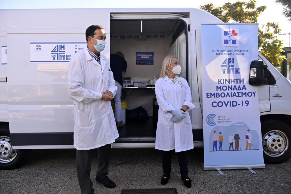 FILE - Medical staff stand outside a mobile COVID-19 vaccination team set up by Health Ministry in the northern city of Thessaloniki, Greece on Tuesday, Oct. 26. 2021. (AP Photo/Giannis Papanikos, File)