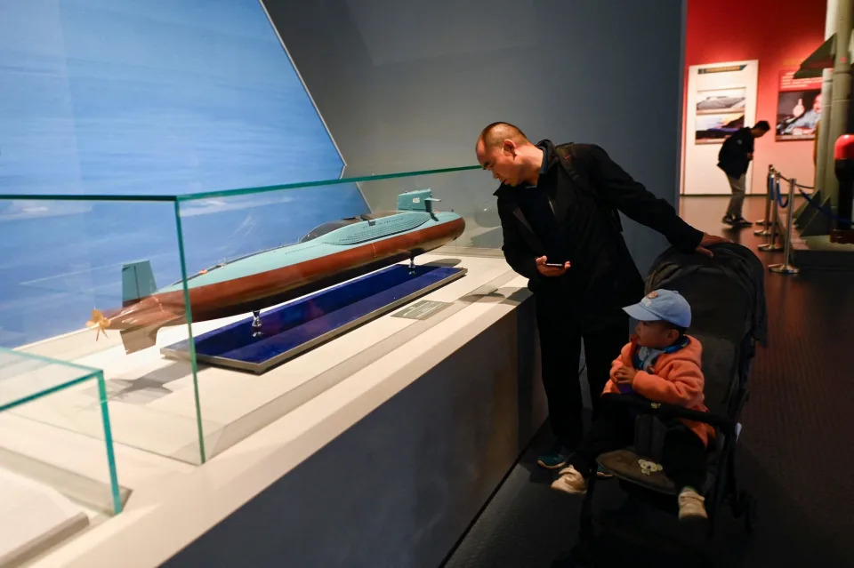 A man looks at a model of the Type 092, China's first nuclear-powered ballistic missile submarine of which only one was built.