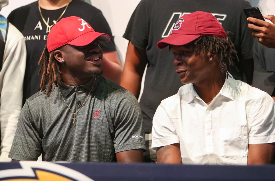 Richard Young and Kelton Henderson talk to each other during a signing day celebration  at Lehigh Senior High School in Lehigh Acres on Wednesday, Dec. 21, 2022. Young signed with the university of Alabama and Henderson signed with the University of South Carolina.