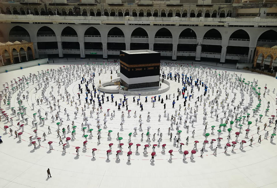 Hundreds of Muslim pilgrims circle the Kaaba, the cubic building at the Grand Mosque, as they observe social distancing to protect themselves against the coronavirus, in the Muslim holy city of Mecca, Saudi Arabia, Wednesday, July 29, 2020 During the first rites of hajj, Muslims circle the Kaaba counter-clockwise seven times while reciting supplications to God, then walk between two hills where Ibrahim's wife, Hagar, is believed to have run as she searched for water for her dying son before God brought forth a well that runs to this day. (AP Photo)