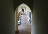 A man walks at College Notre Dame de Nazareth which was damaged due to the explosion at the port area, in Beirut