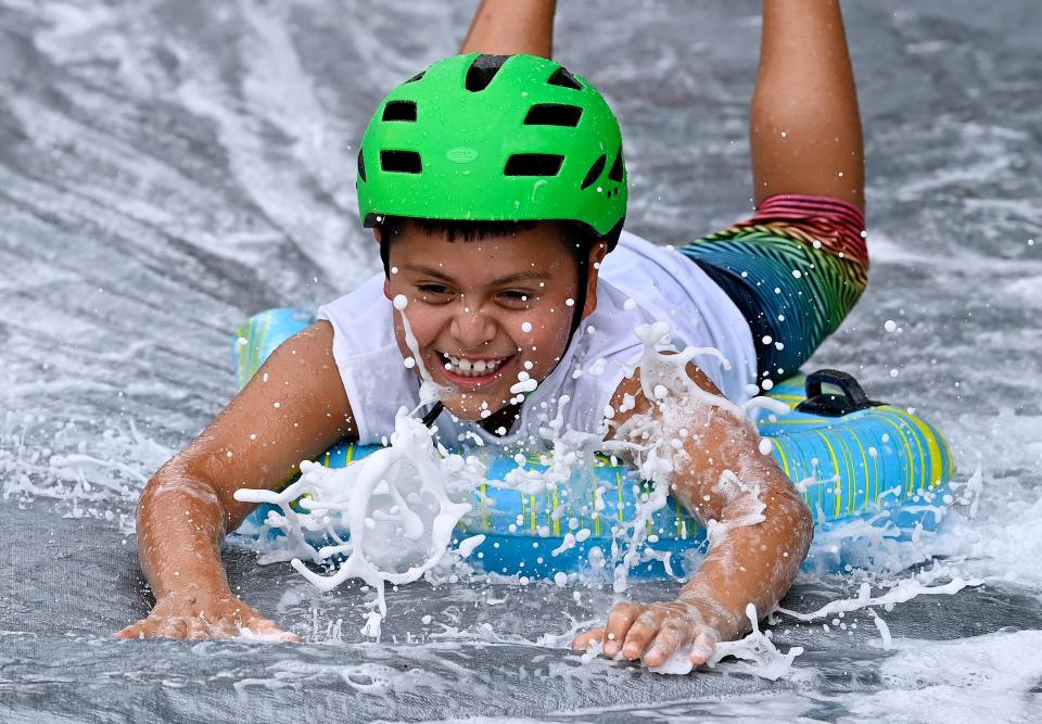 Jadrian Lopez slides on the firefighter challenge during Camp Hope in Columbia, The four-day camp, hosted by the Vanderbilt Burn Center, is designed to empower, celebrate and give space for healing for kids who have burn injuries.