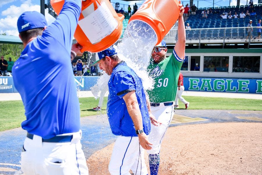 FGCU baseball coach Dave Tollett gets doused with water after winning his 700th career game on Sunday against Jacksonville State.