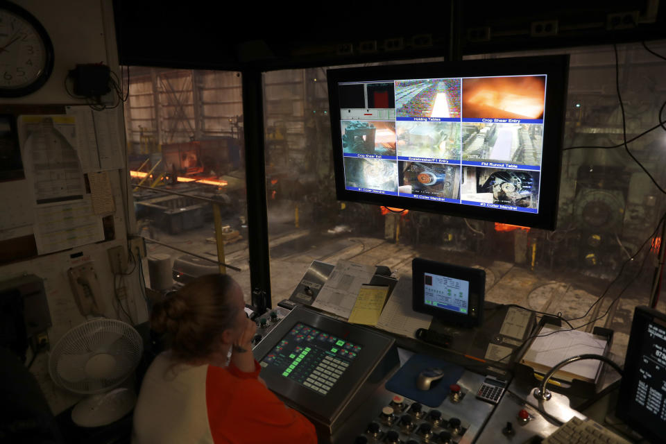 FILE- In this June 28, 2018, file photo steelworker Amanda Menendez keeps watch over various stages of the production process on monitors in an office above as steel is produced on the floor below inside the hot-strip mill at the U.S. Steel Granite City Works facility in Granite City, Ill. President Donald Trump’s decision last year to tax imported steel tested the limits of his legal authority, strained relations with key U.S. allies and imposed higher costs and uncertainty on much of American industry. But his 25% tariffs haven’t even done much for the companies they were supposed to help. (AP Photo/Jeff Roberson, File)