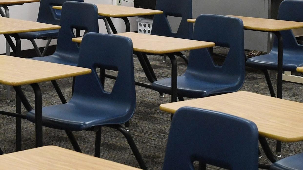 Desks line a classroom in the U.S.